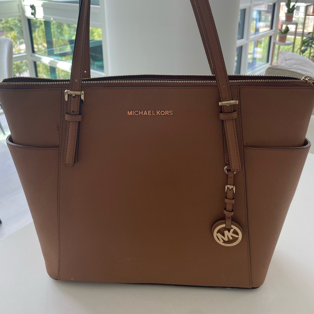 In good condition- camel work bag. Can fit laptop easily with additional space.